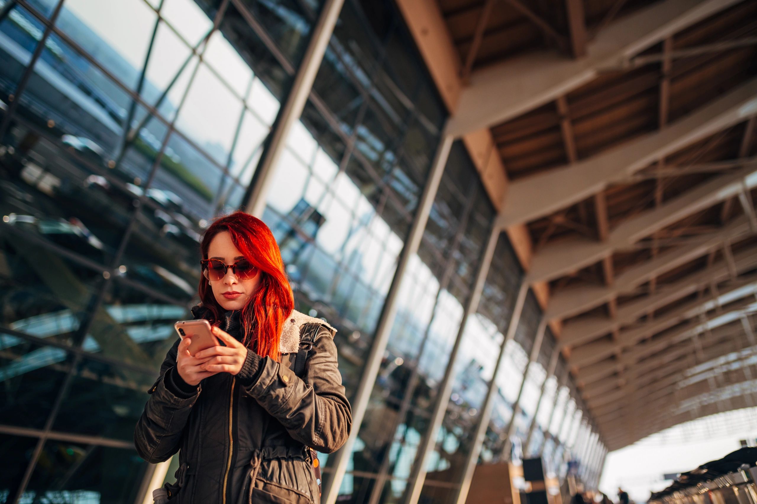 Traveler using a mobile phone at an airport terminal