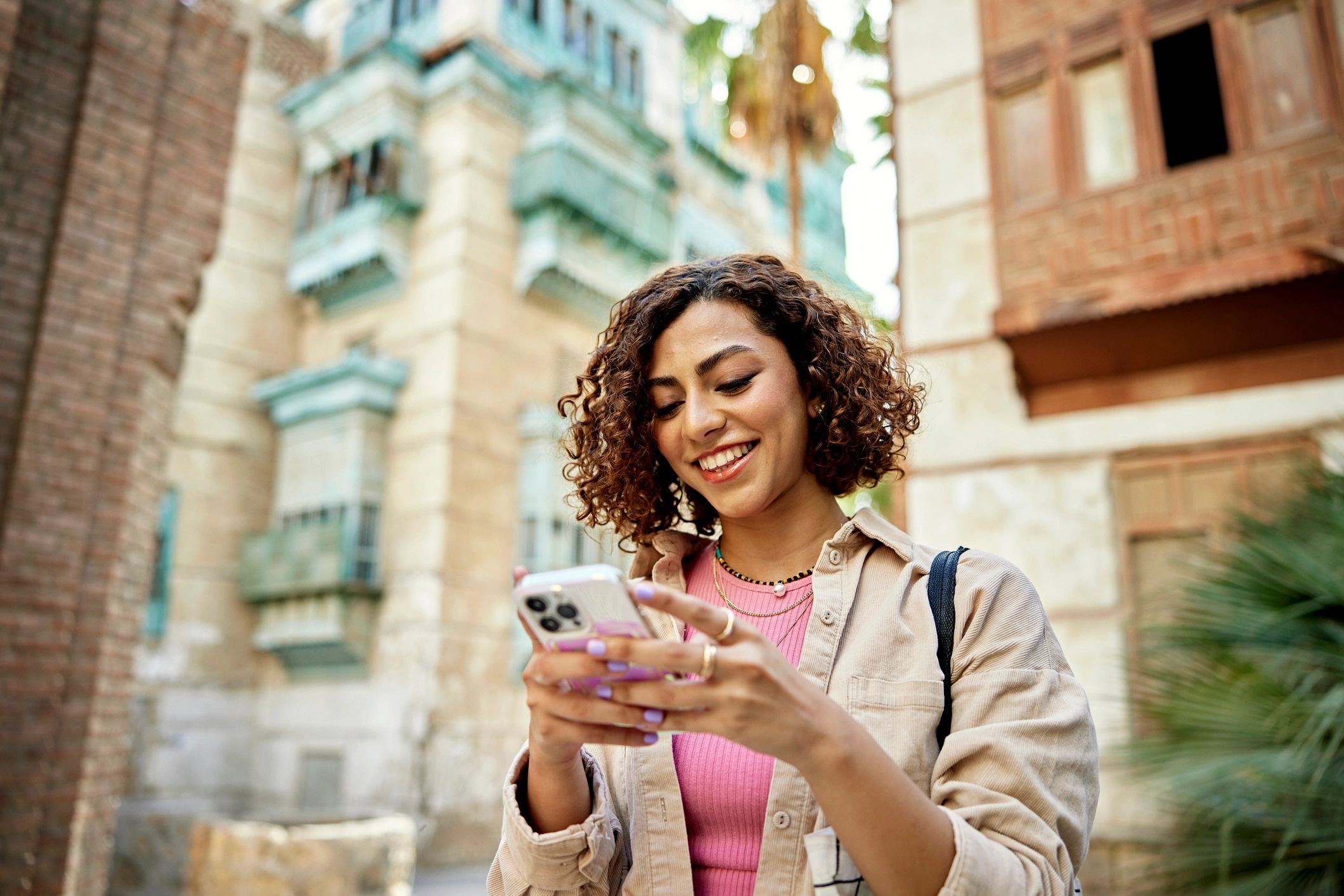 Traveler using a smartphone while exploring a city
