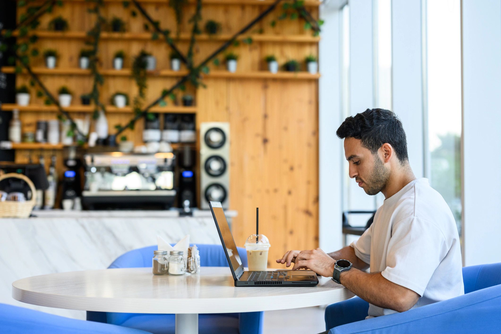 Digital nomad working on a laptop in a cafe