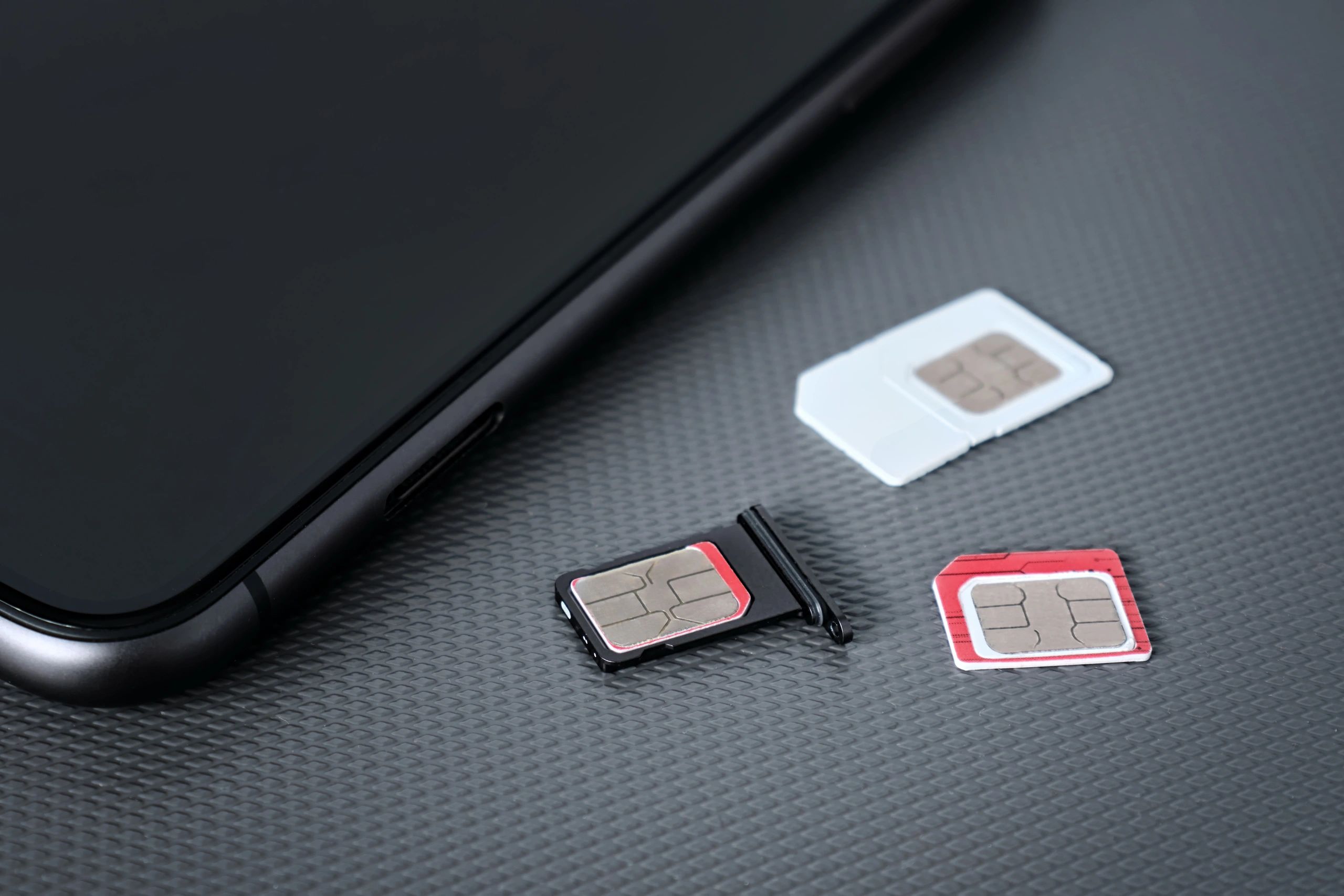 SIM cards next to a smartphone