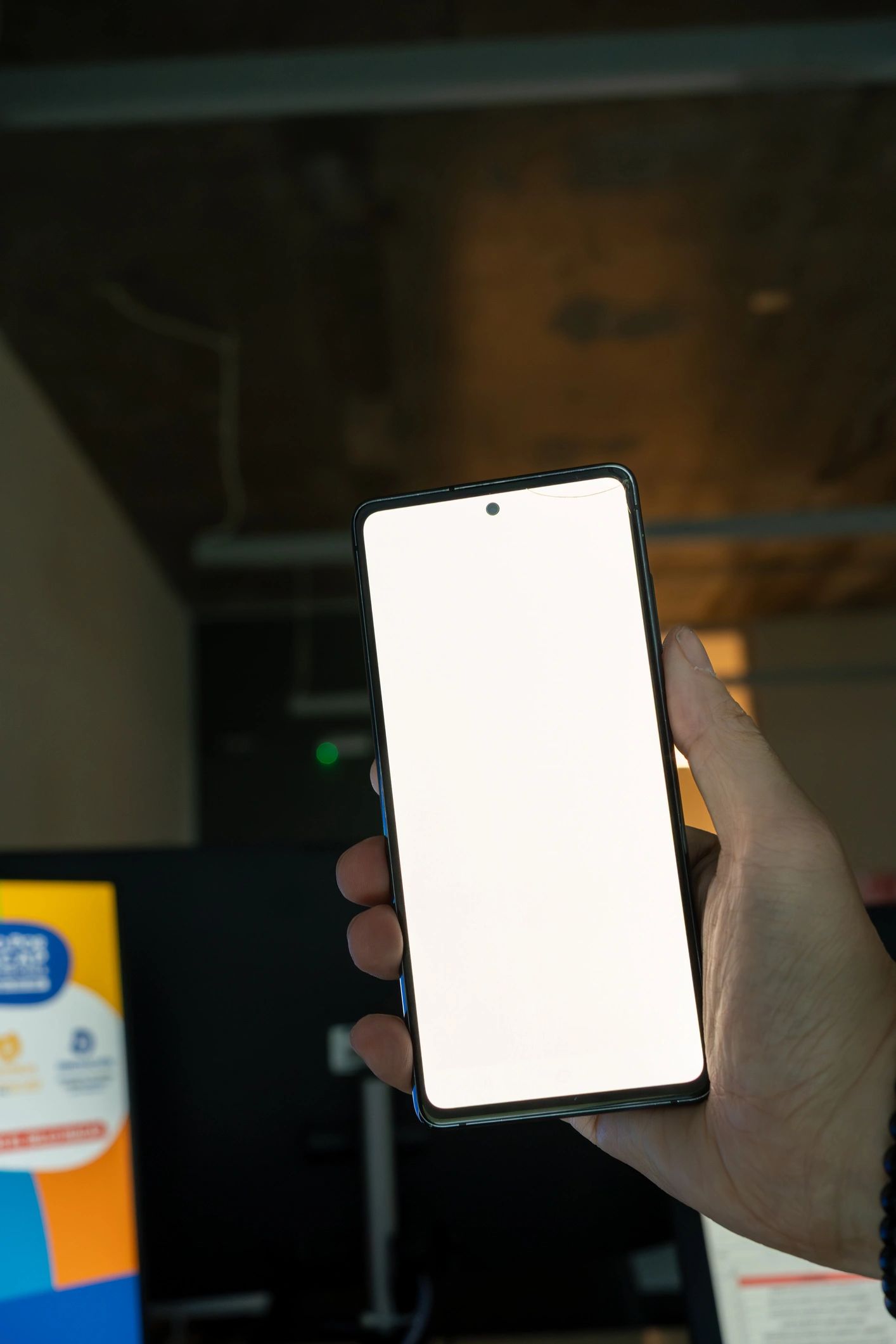 Hand holding a smartphone showing a setup screen