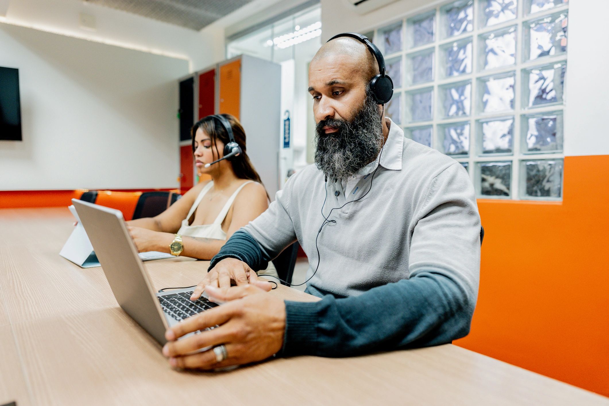 Customer support representative working at a laptop
