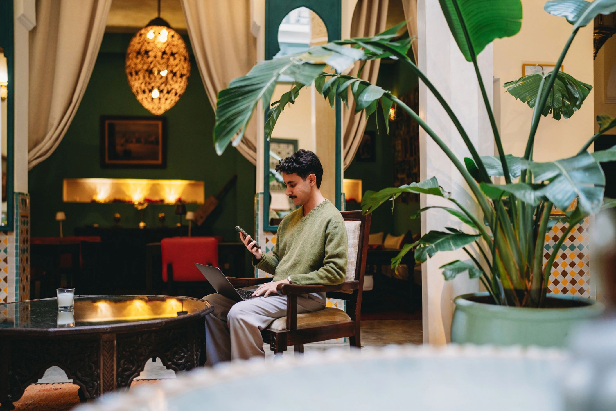 Remote worker using a laptop and smartphone